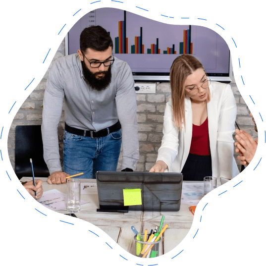 Two professionals collaborating on a digital project at a modern workstation, representing Devvisionary's partnership approach.